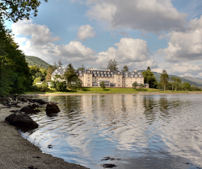 The Ardgartan hotel, overlooking a loch and surrounded by a forest 